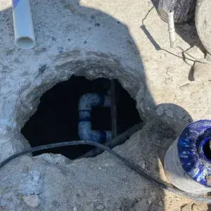 Concrete deck cut open exposing underground pool plumbing during a leak detection service